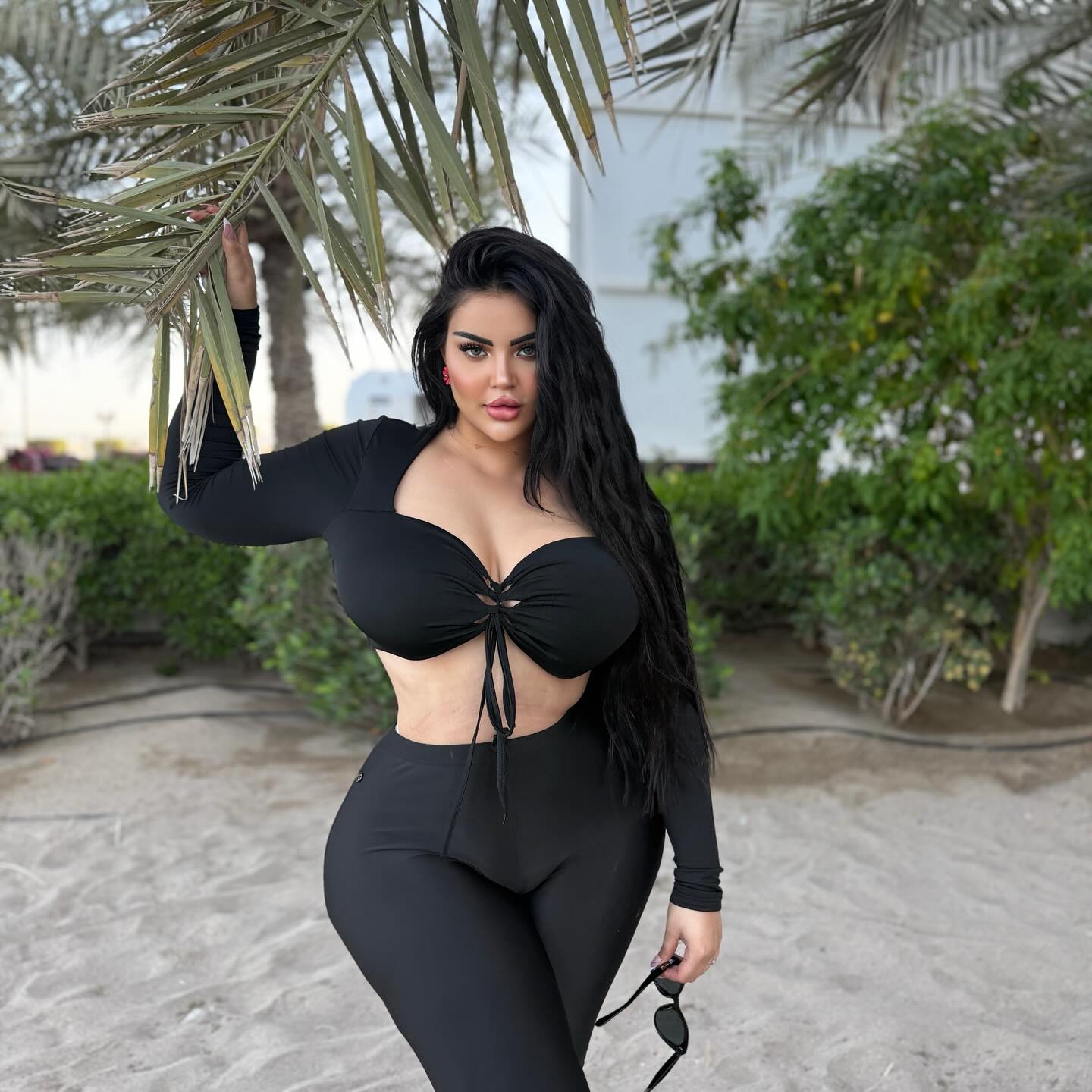 Image of Chayma Allam  💎 | شيماء علام from Instagram fashion, black outfit, crop top, leggings, beach, sunglasses, barefoot