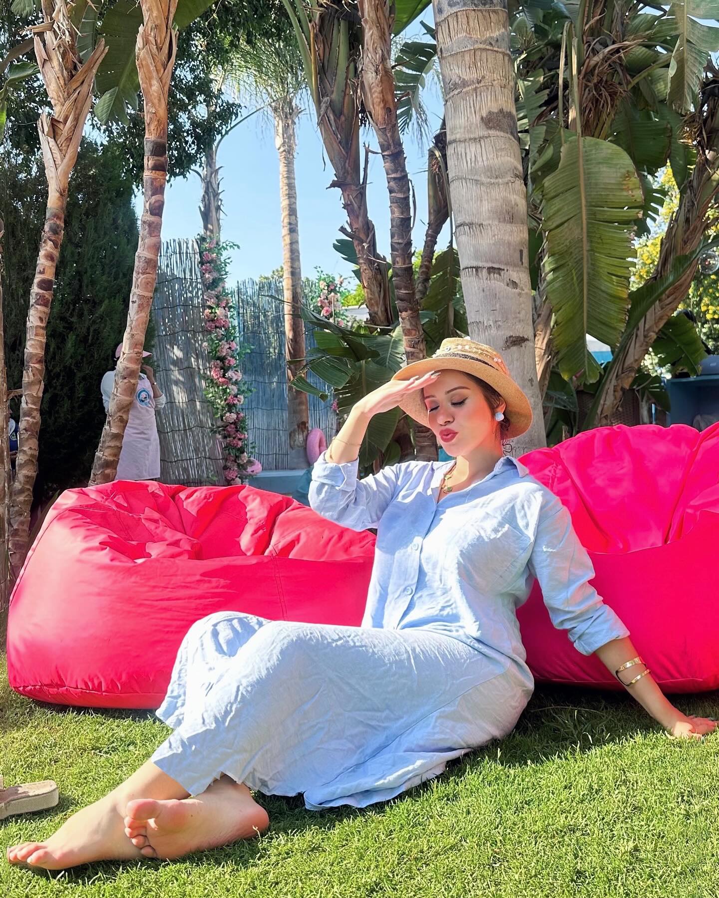 Image of • Salma yehia from Instagram hat, dress, barefoot, outdoors, garden, relaxed