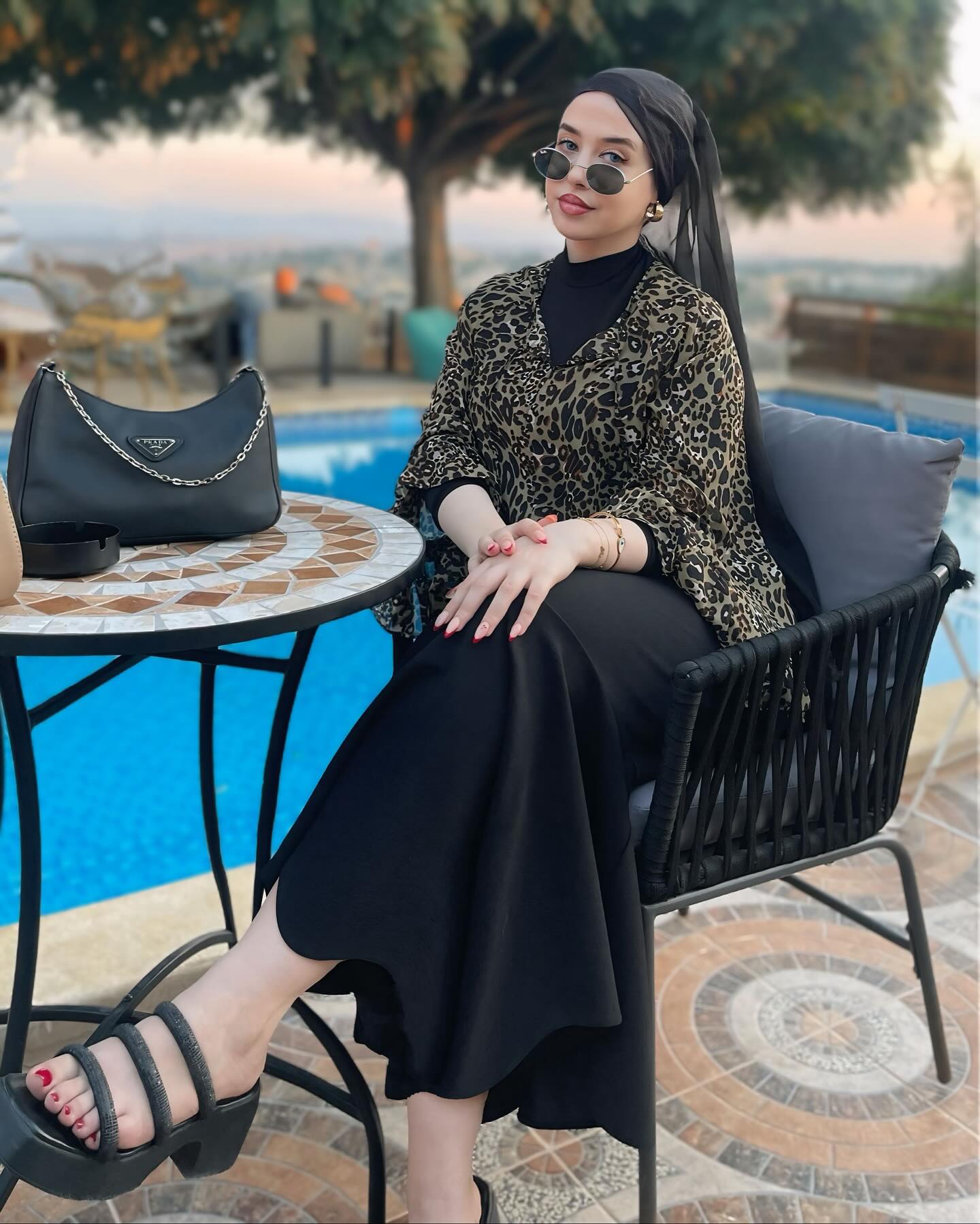 Image of R Y M  |  ريم 💎 from Instagram leopard print, black dress, headscarf, sunglasses, sandals, poolside, bag