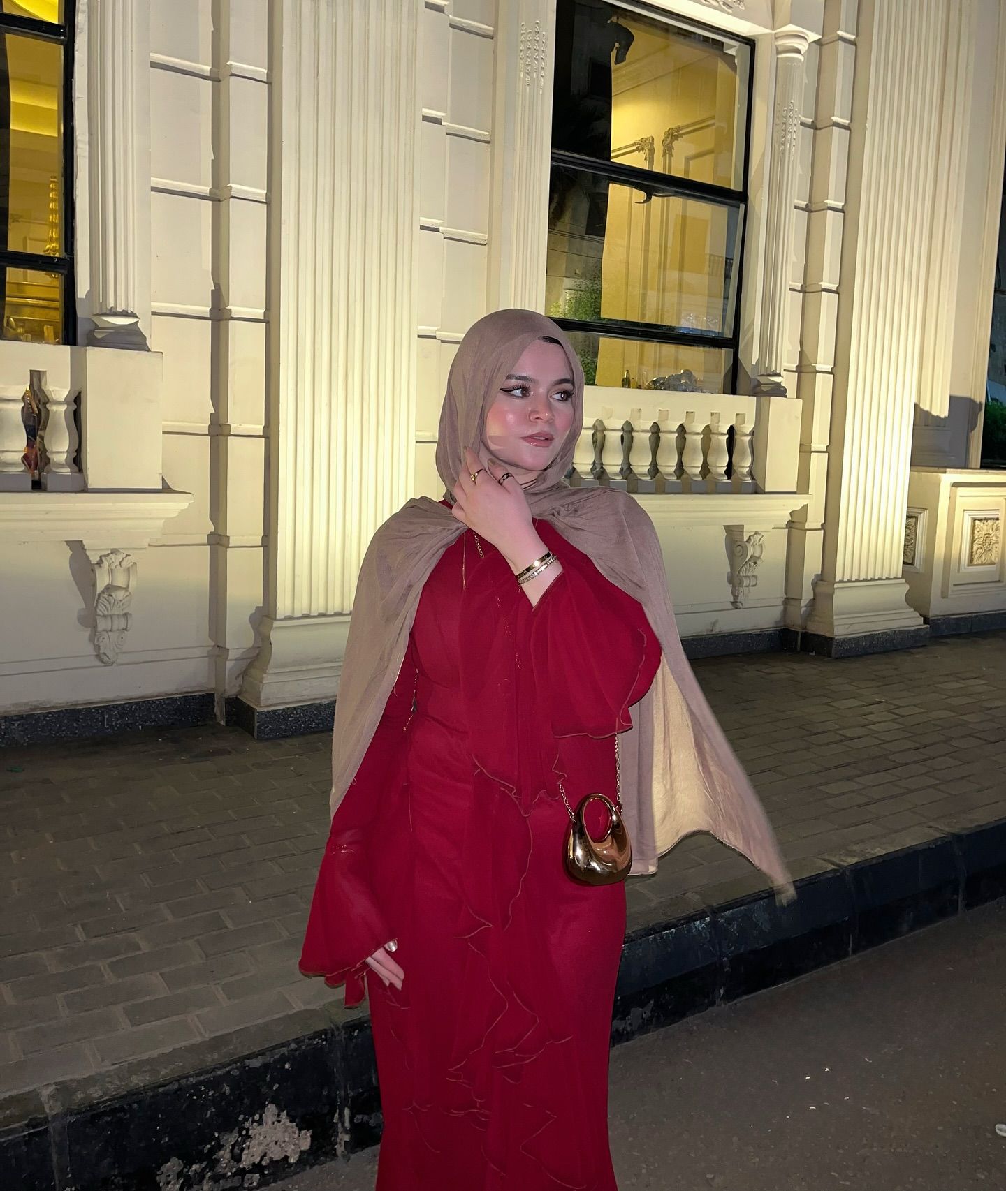 Image of Basma Allam | بسمة علام from Instagram red dress, beige hijab, small purse, night, outdoor, bracelet, rings