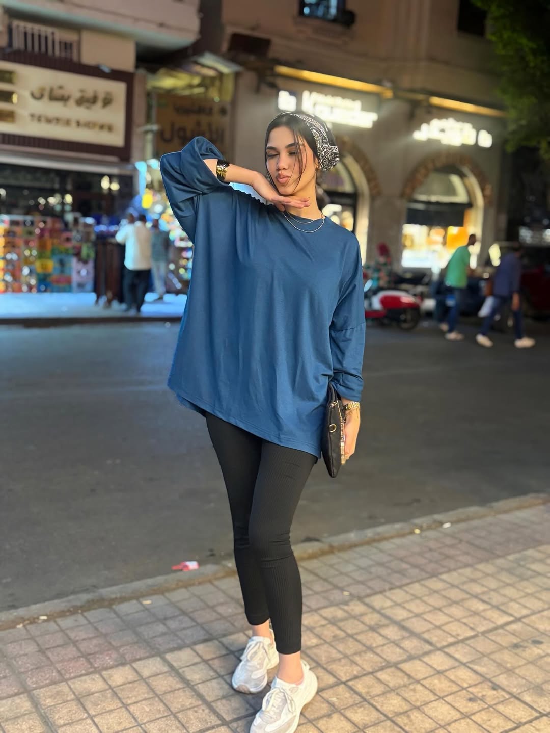 Image of Abrar_Mohamed.14 from Instagram blue top, black leggings, white sneakers, headscarf, clutch, bracelet, necklace, night street