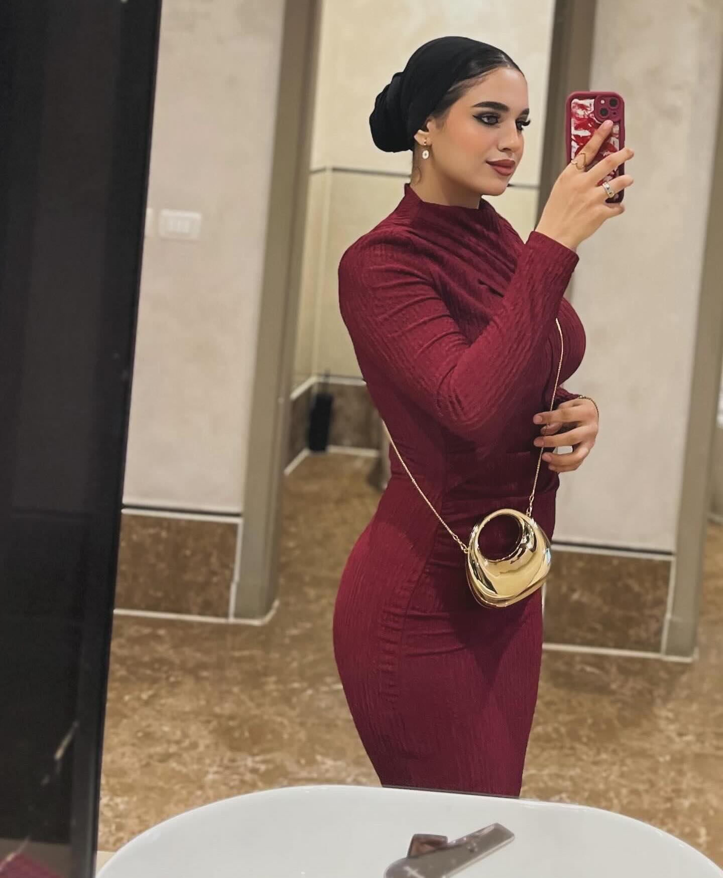 Image of كارلا مصطفي |carla mostafa ✨ from Instagram burgundy dress, long sleeves, gold handbag, accessories, stylish, elegant, mirror selfie