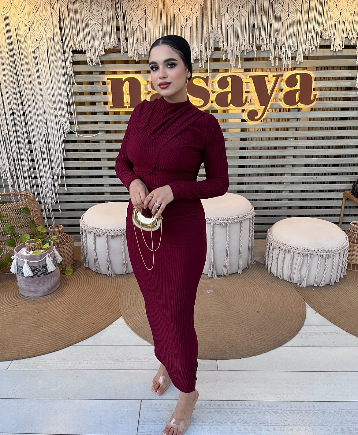 Image of كارلا مصطفي |carla mostafa ✨ from Instagram burgundy dress, long sleeves, clear heels, gold accessories, elegant look, modern style, chic outfit, stylish clutch, bohemian backdrop