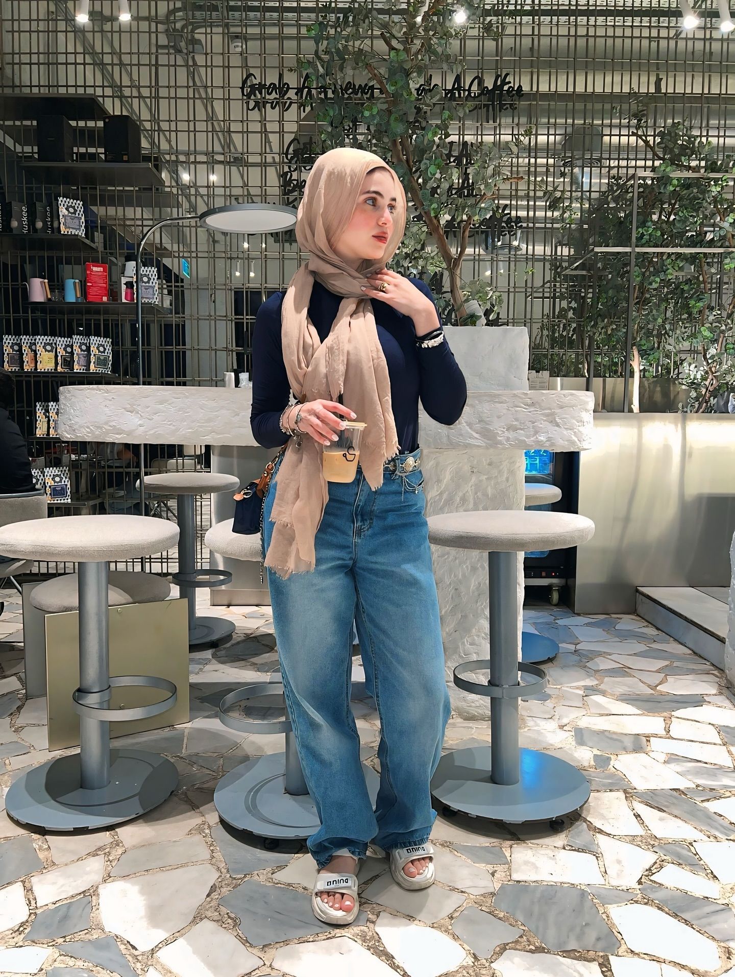 Image of Rehab Amgad from Instagram hijab, casual, jeans, long-sleeve, sandals, scarf, coffee, cafe