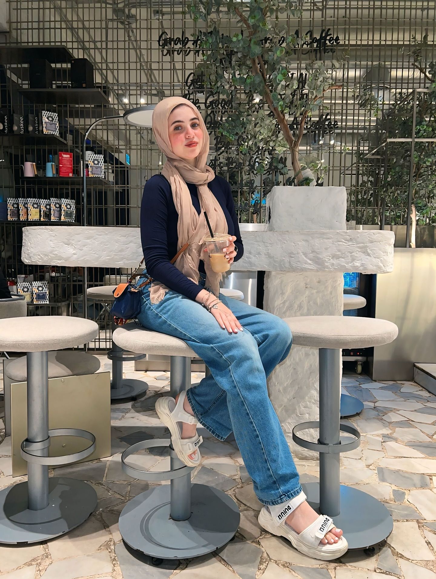 Image of Rehab Amgad from Instagram hijab, navy top, blue jeans, sandals, casual, stylish, accessories