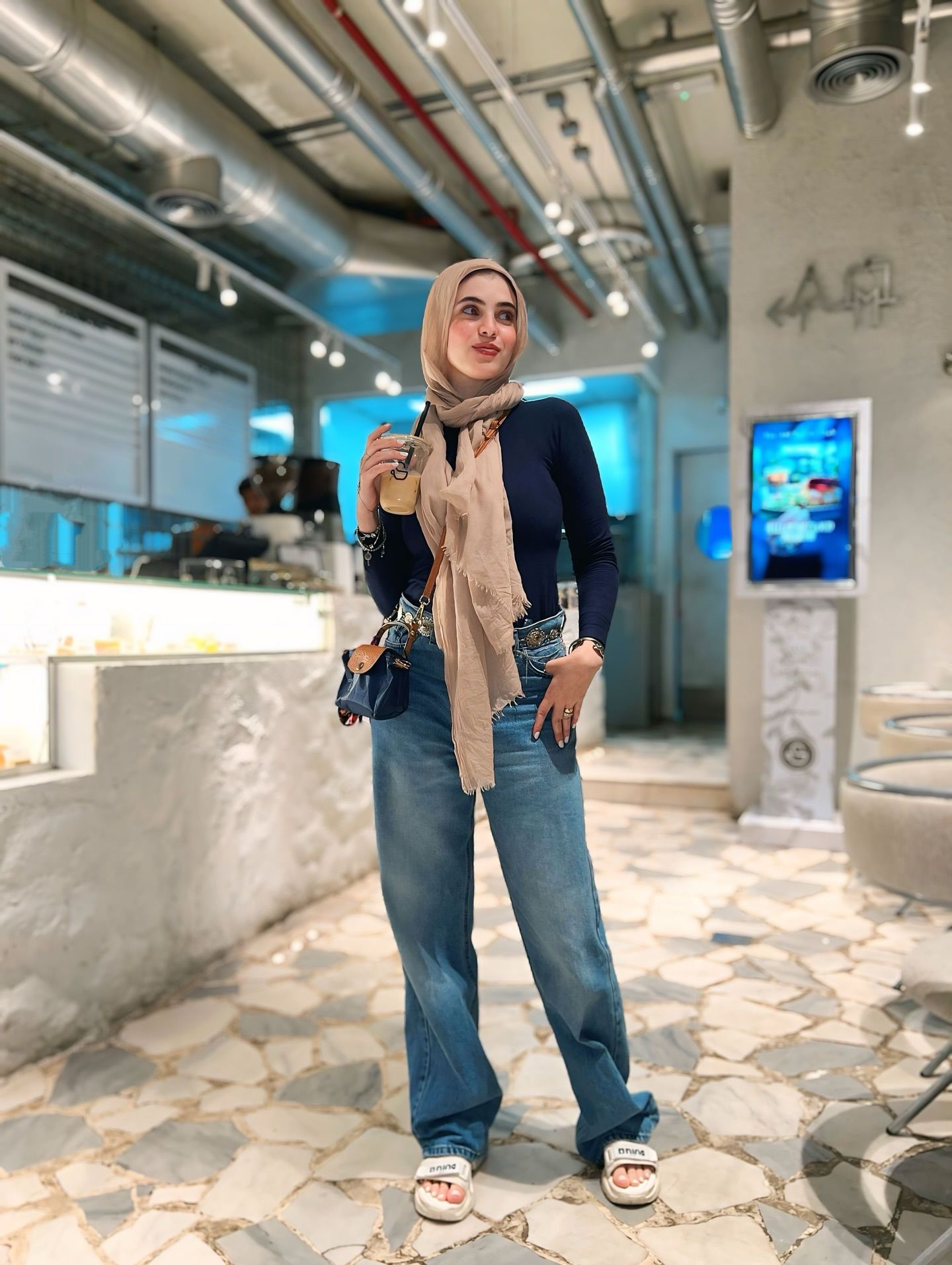 Image of Rehab Amgad from Instagram hijab, scarf, blouse, jeans, sandals, bag, indoor