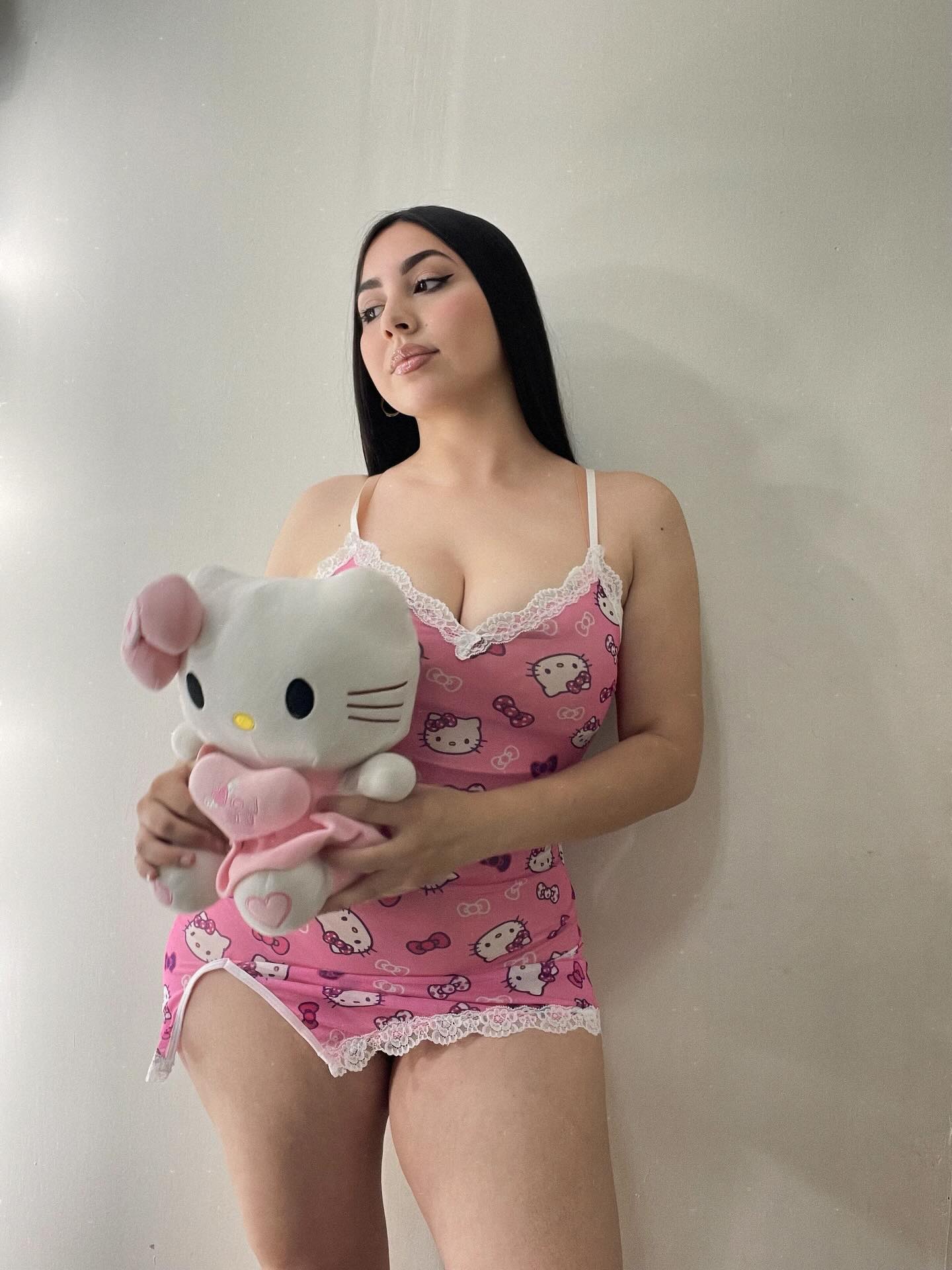 Image of Génesis Ortiz from Instagram pink dress, Hello Kitty, lace trim, teddy bear, indoors, barefoot
