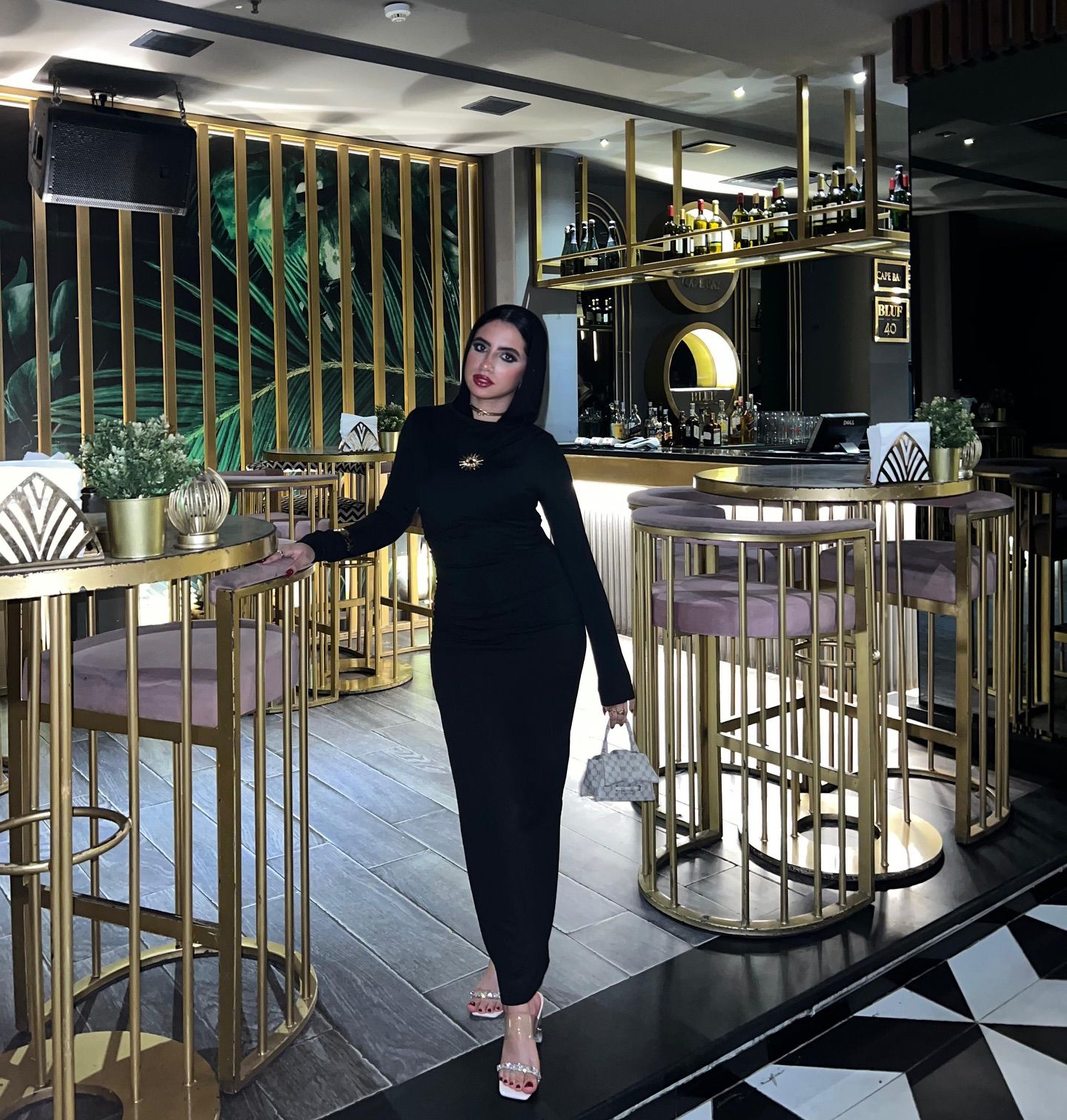 Image of Rawan Osman | روان عثمان from Instagram black dress, silver heels, handbag, bar