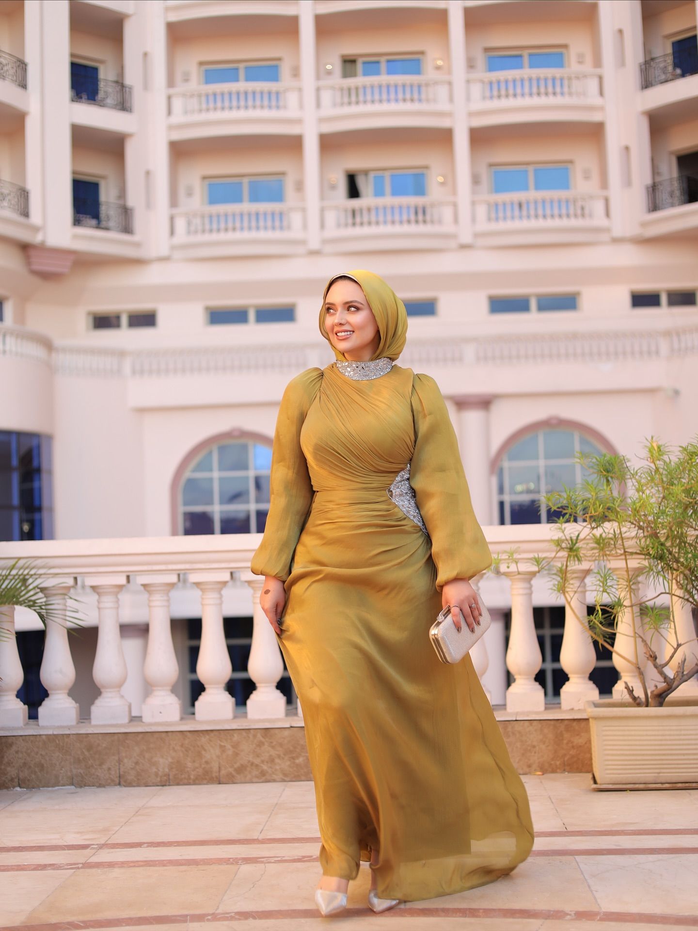 Image of ميرنا عبدالوهاب from Instagram dress, hijab, clutch, heels, balcony, building