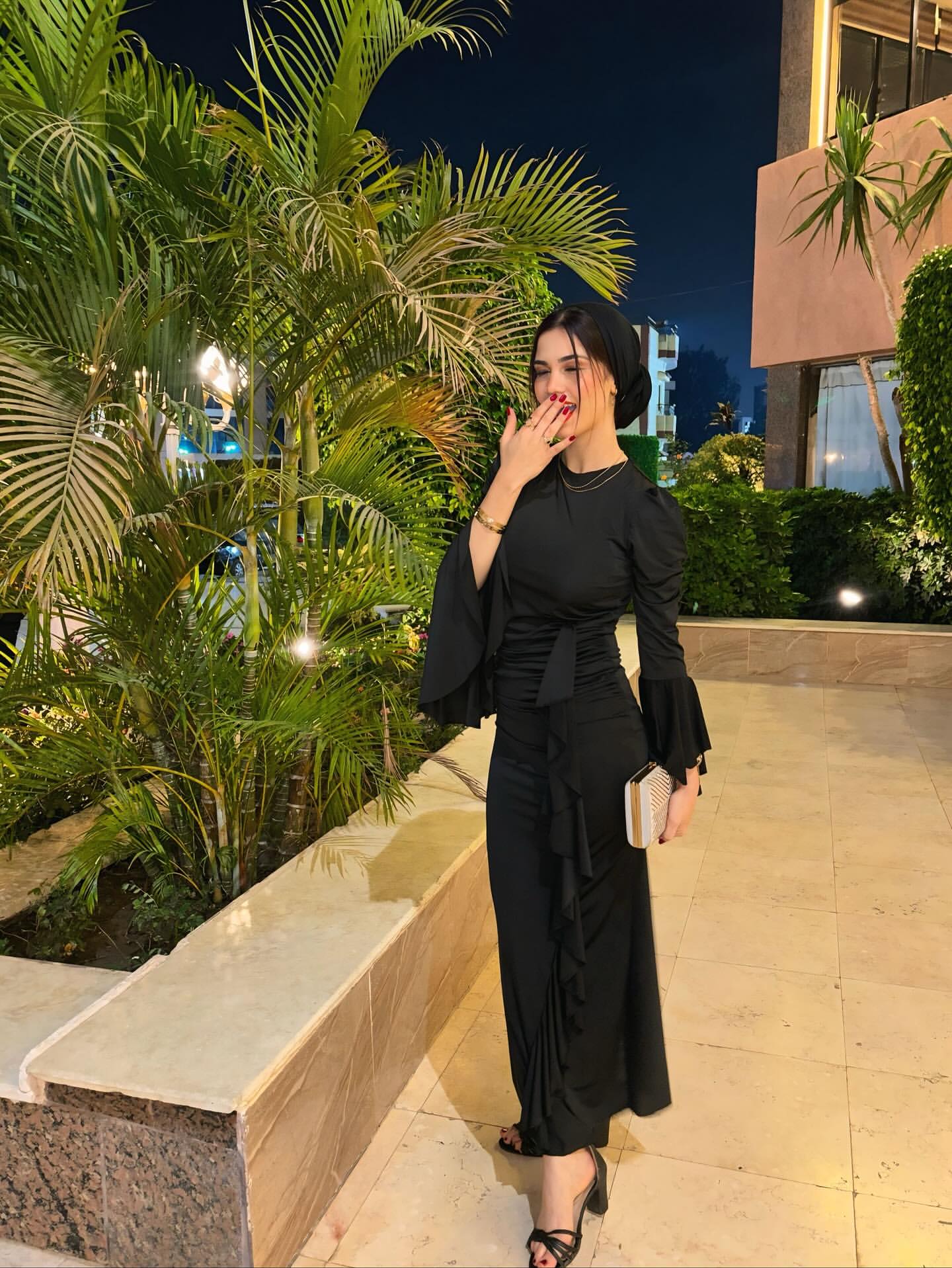 Image of Abrar_Mohamed.14 from Instagram black dress, flowing sleeves, gold jewelry, clutch, sandals, evening wear, elegant