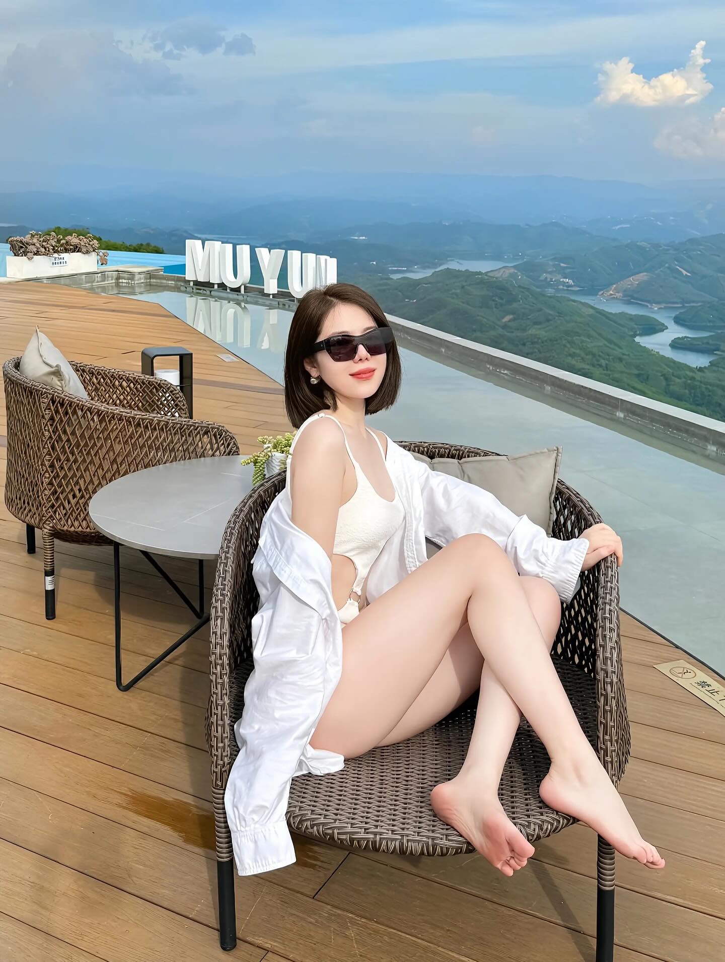 Image of InsomniacCat from Instagram sunglasses, white swimsuit, white cover-up, barefoot, outdoor seating, scenic view