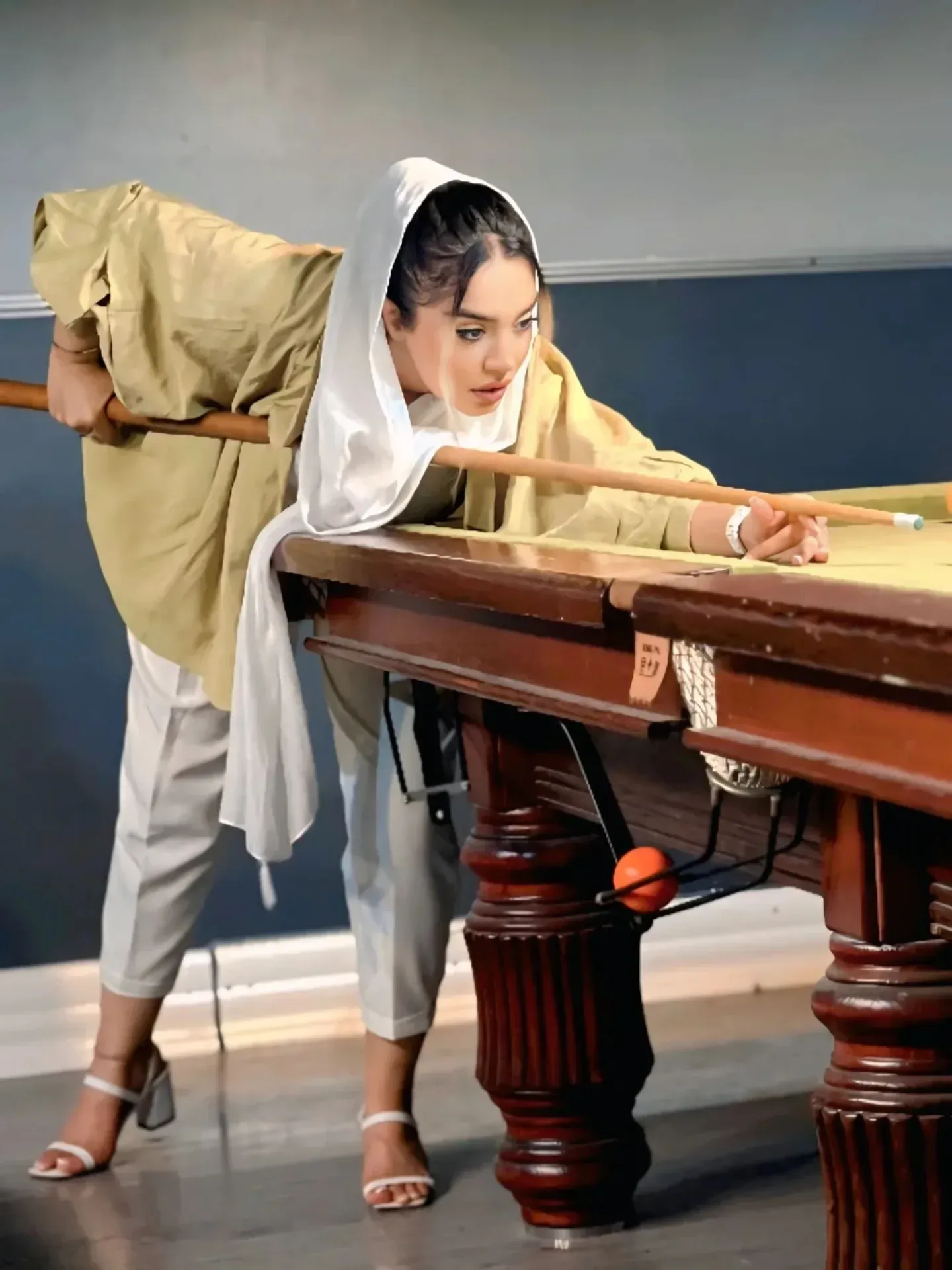 Image of شمارو دنبال میکند from Instagram white heels, beige outfit, headscarf, pool table