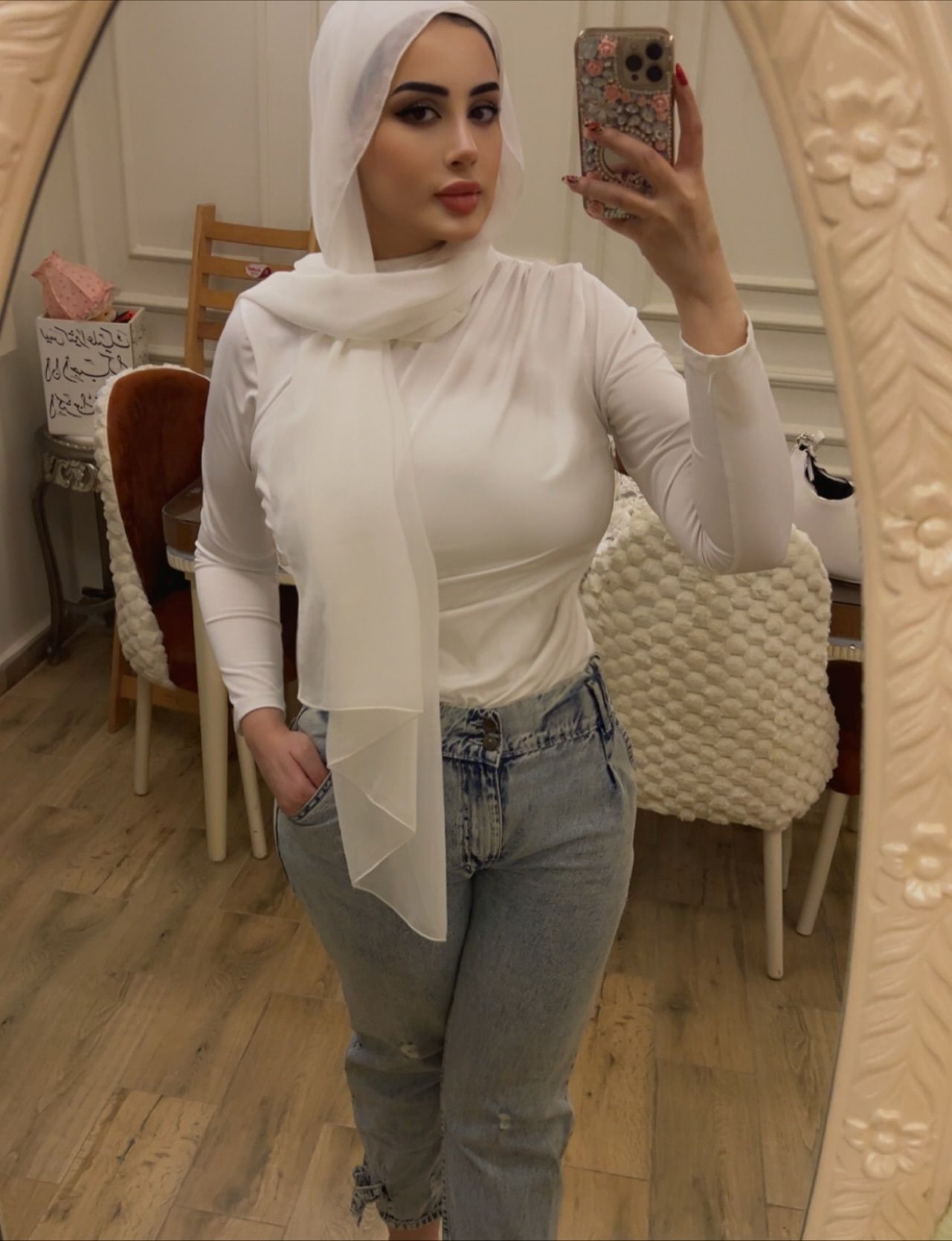 Image of Nourhan Mohamed from Instagram white top, hijab, jeans, mirror selfie, indoor, barefoot