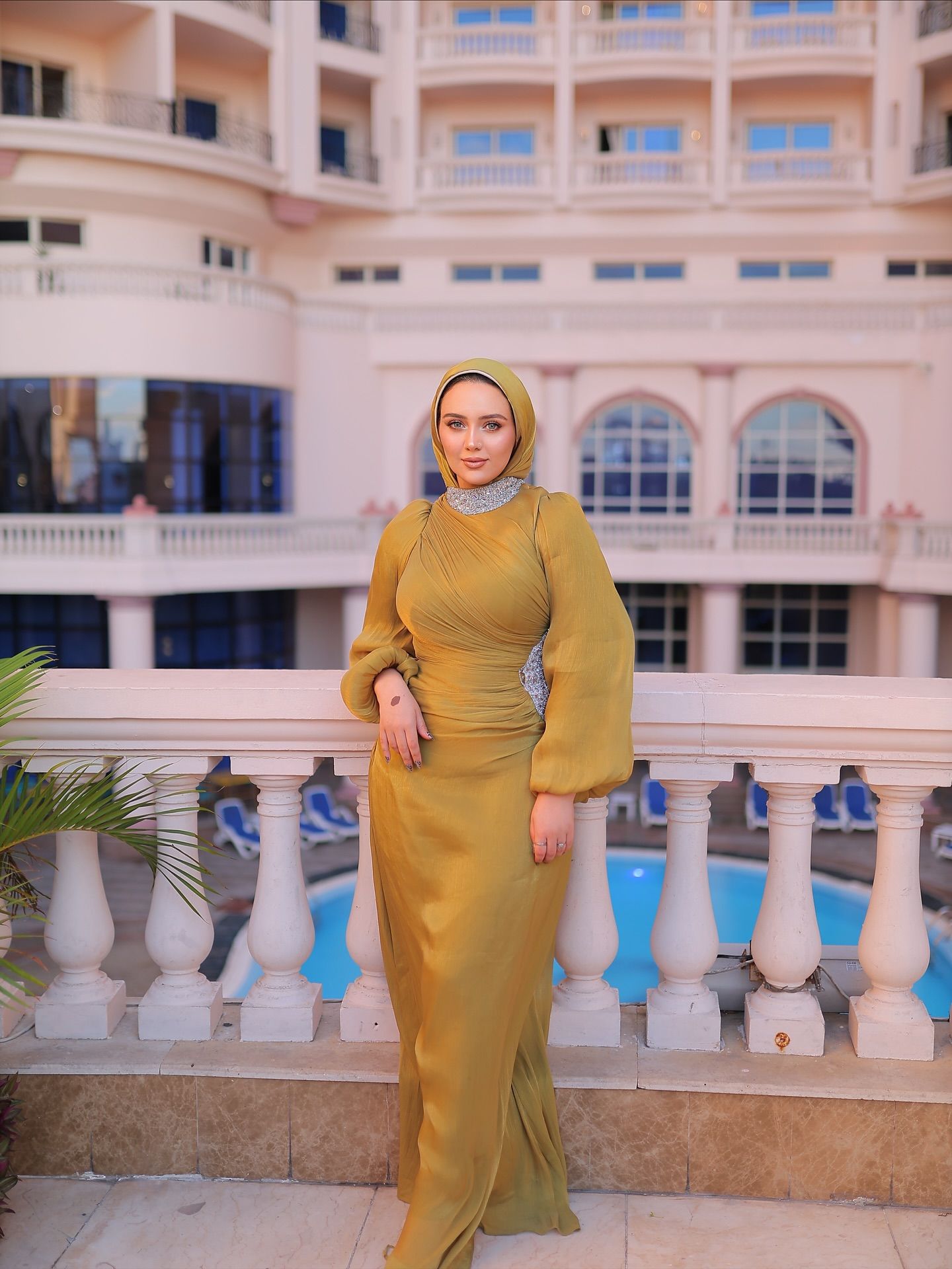 Image of ميرنا عبدالوهاب from Instagram gown, hijab, elegant, mustard color, long sleeves, poolside, chic, glamorous