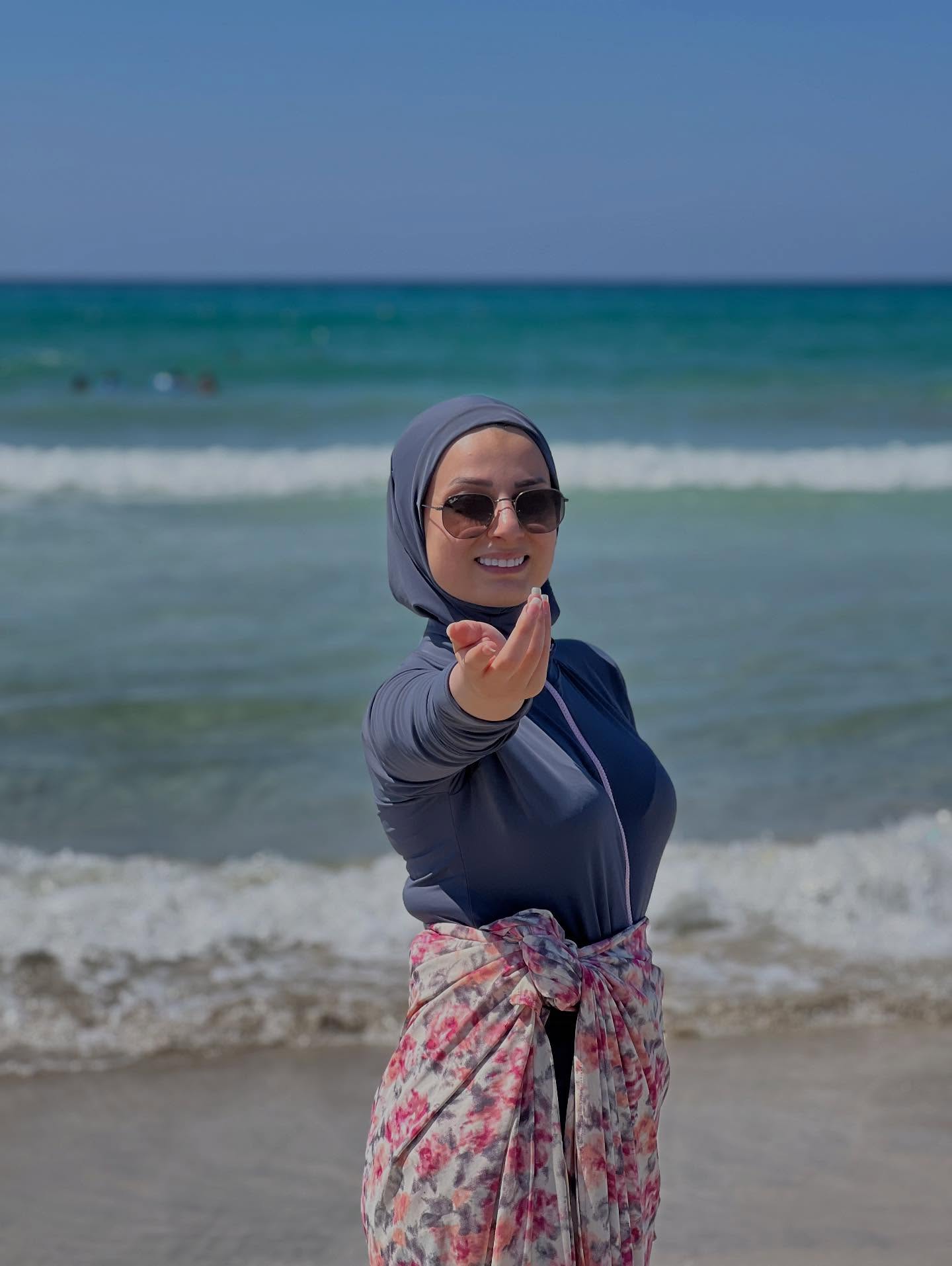 Image of عليا 🇱🇧 from Instagram beachwear, hijab, sunglasses, floral sarong, long-sleeve, ocean background