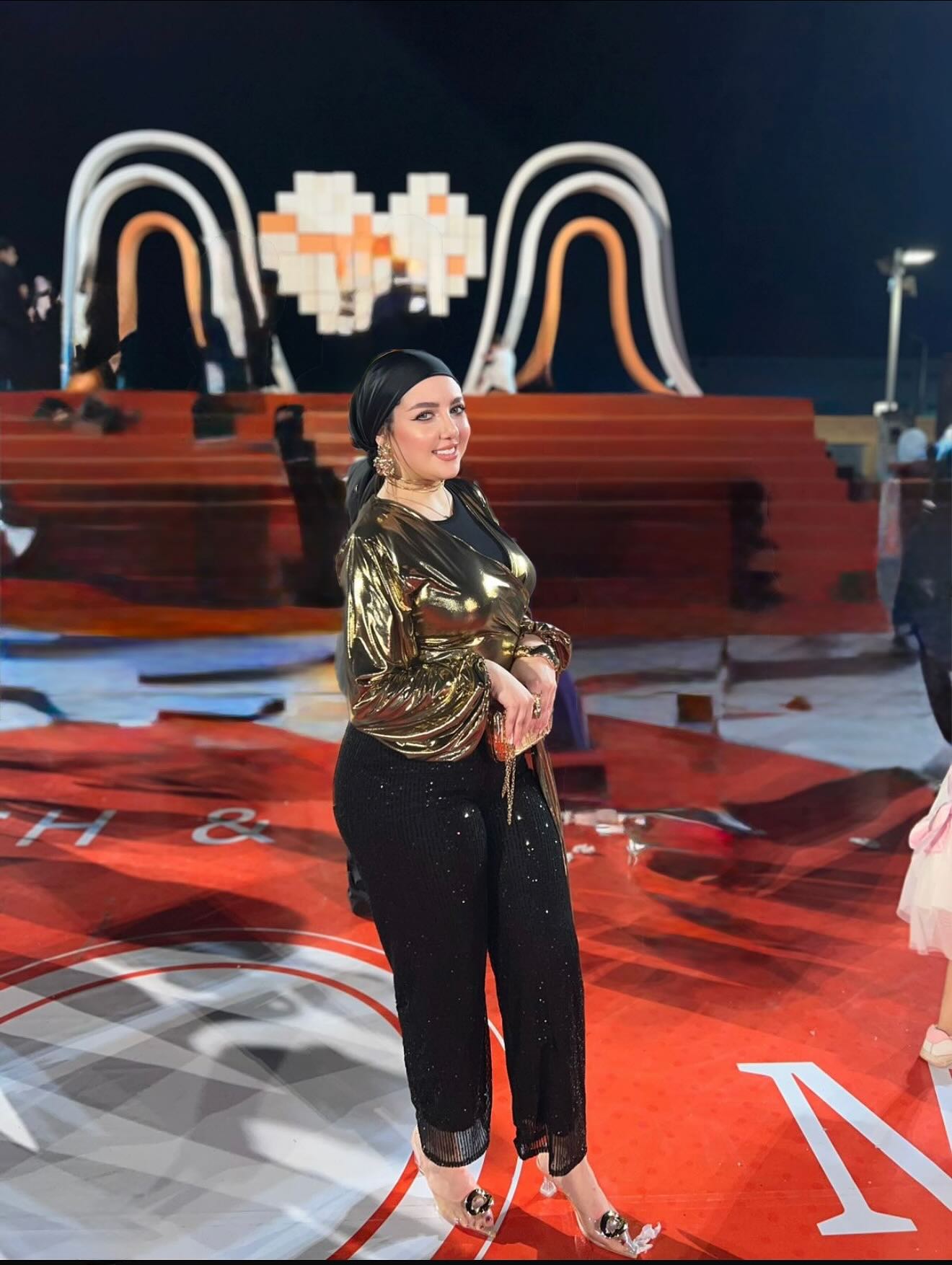 Image of makeup by merna t3ima from Instagram gold blouse, black sequined pants, black turban, gold earrings, clear heels, elegant, red carpet event