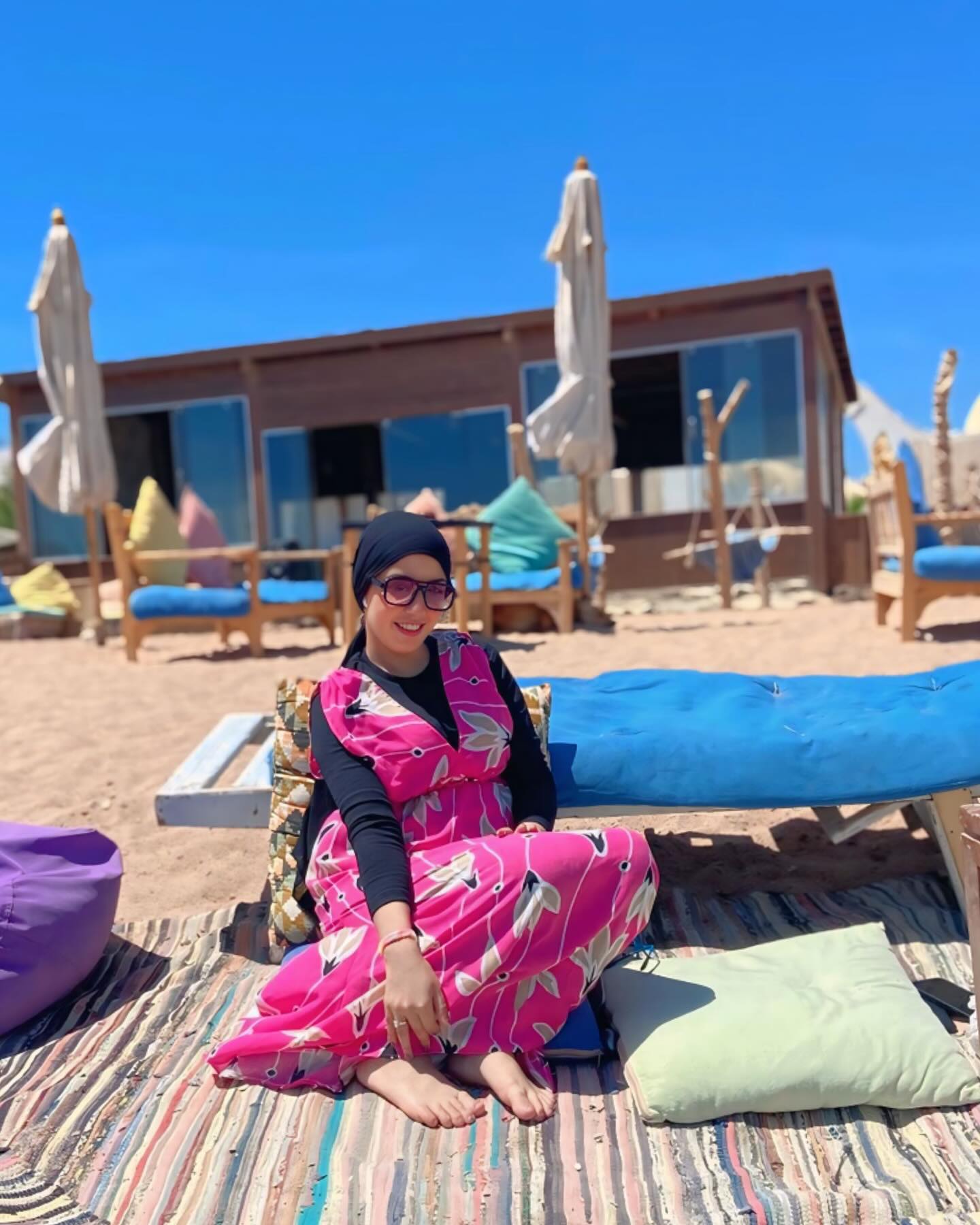 Image of NaDa NabiL-ندي نبيل from Instagram beach, summer, fashion, floral dress, sunglasses, headscarf, barefoot