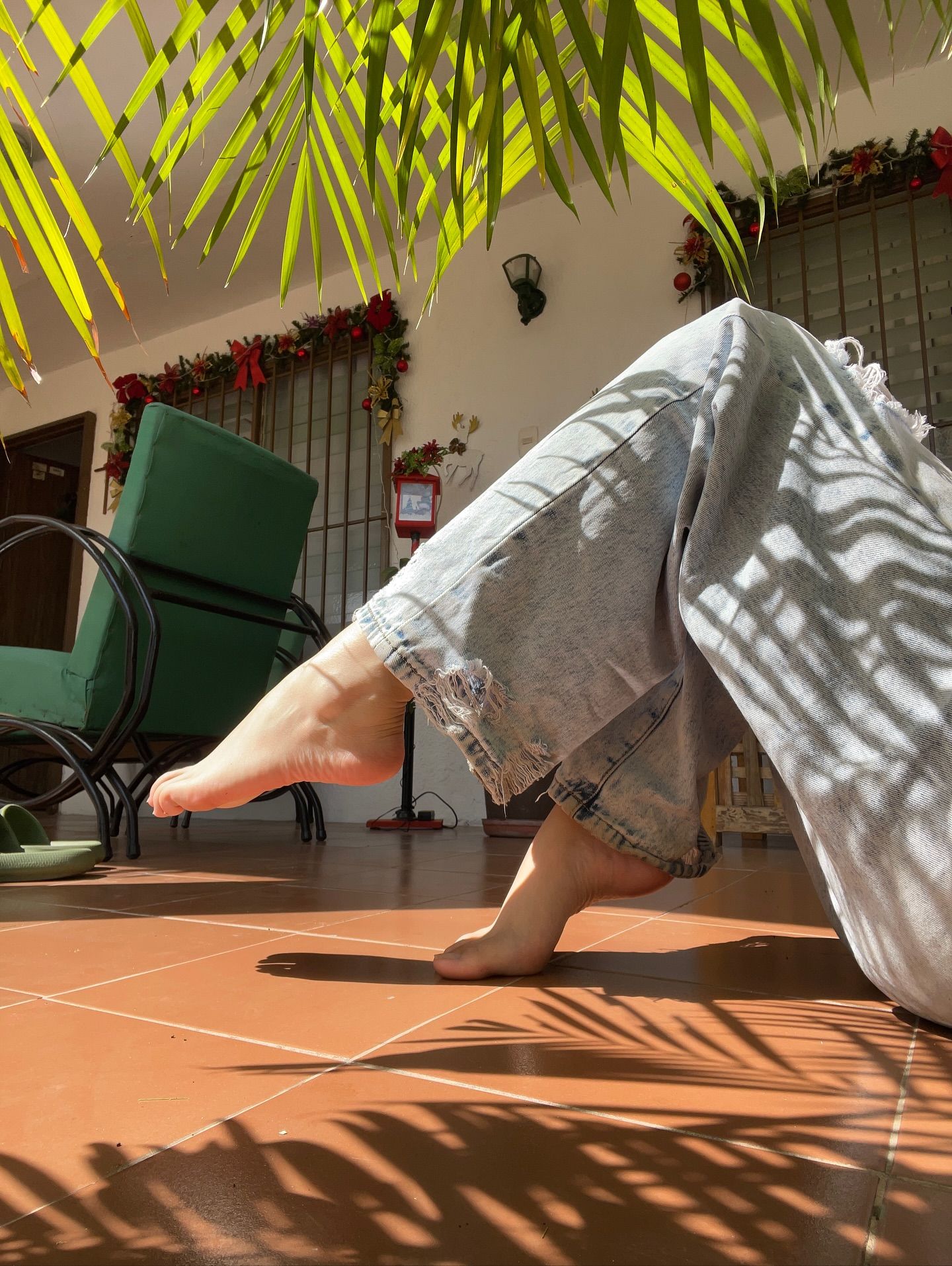 Image of GunButterfly from Instagram barefoot, distressed jeans, casual look, sunny day, green chair, tropical leaves