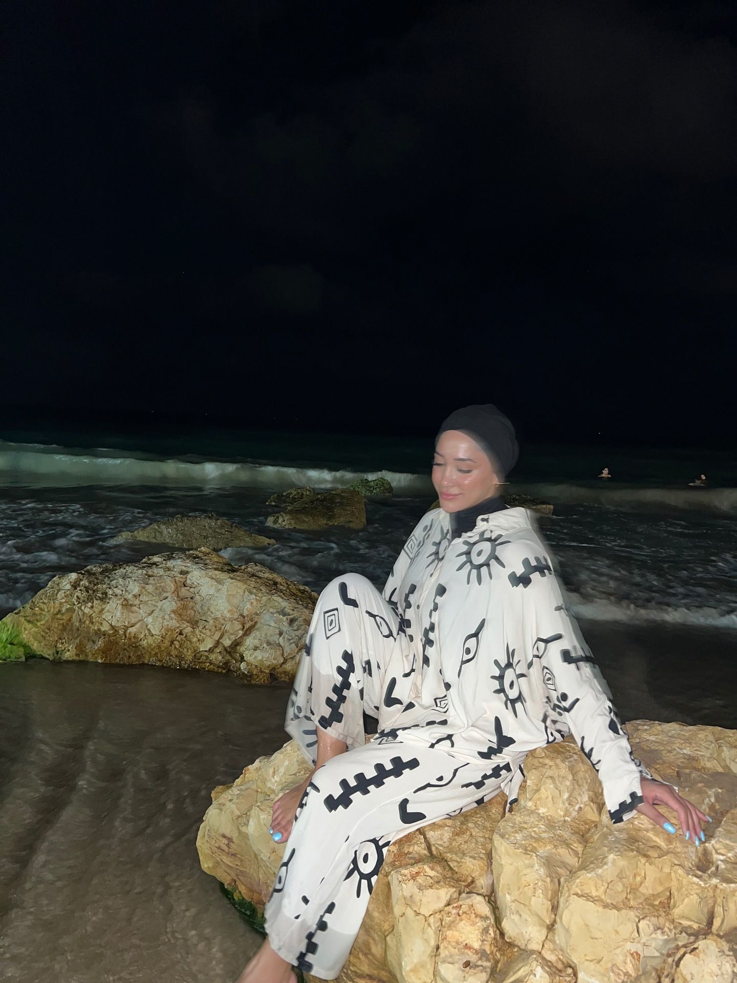 Image of Reem Harisy from Instagram patterned outfit, beach, night, barefoot, headscarf
