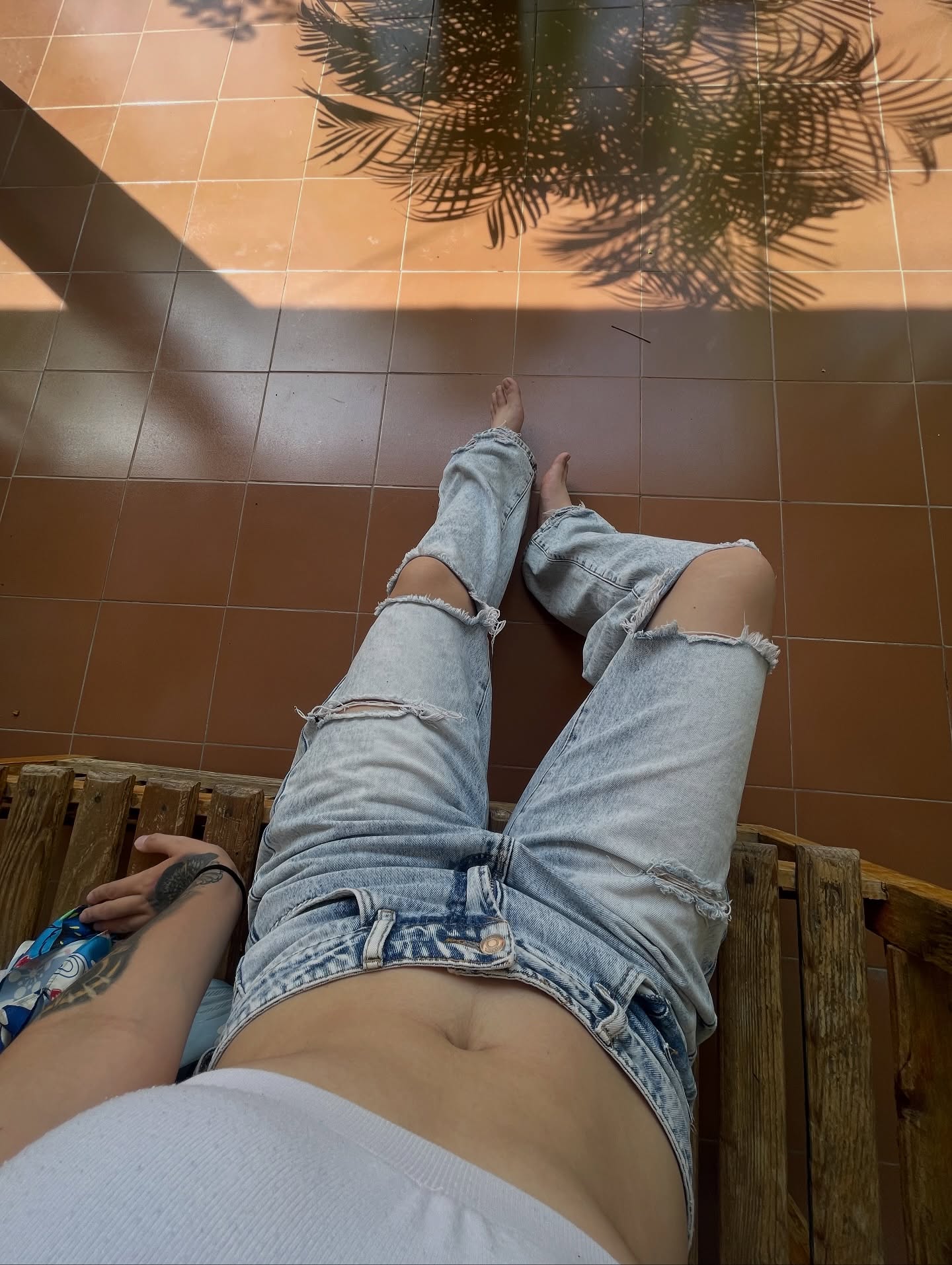 Image of GunButterfly from Instagram white top, ripped jeans, barefoot, casual, outdoor