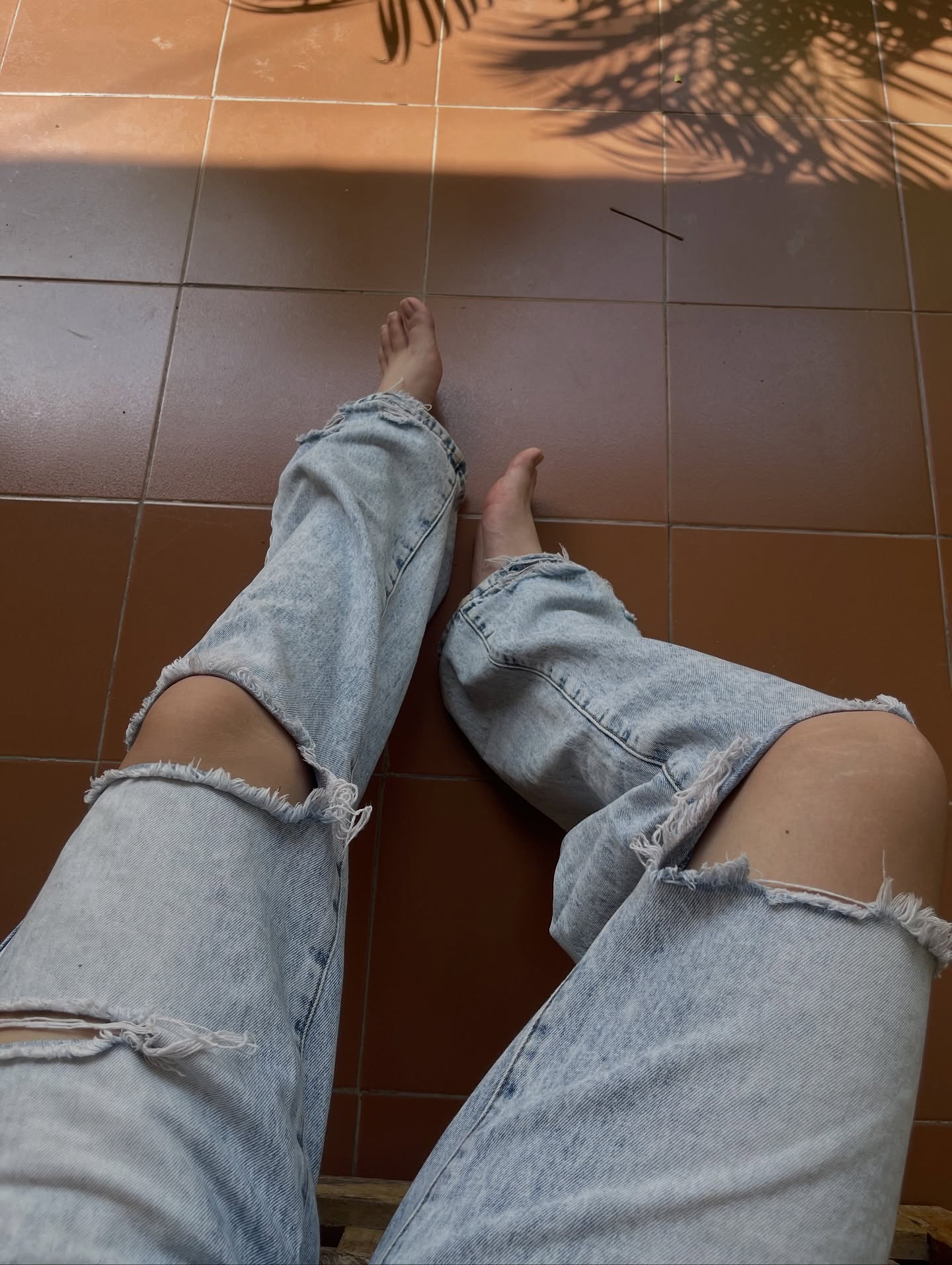 Image of GunButterfly from Instagram ripped jeans, casual wear, barefoot, tiled floor, outdoor