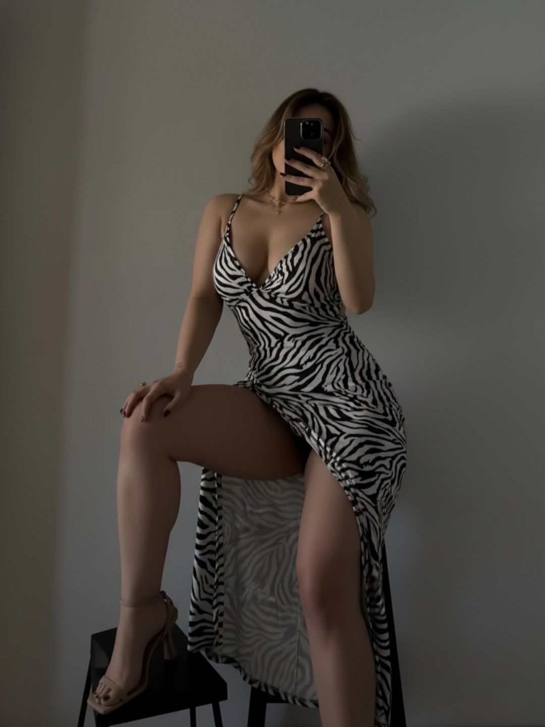Image of Aania 👅 from Instagram zebra print dress, high slit, spaghetti straps, high heels, neutral tones, minimalist background