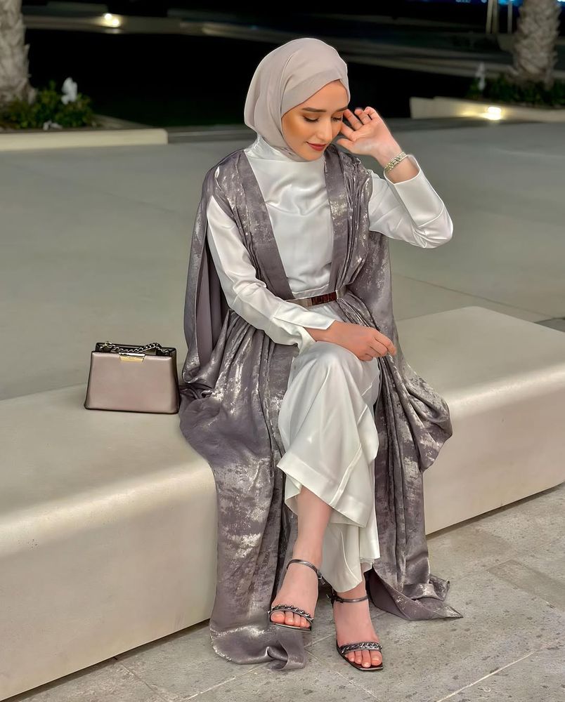 Girl in elegant costume with silver embellished heels in an outdoor setting.