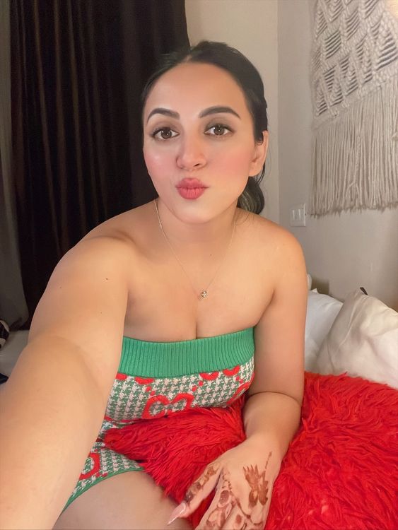 Girl in knitted green strapless top in cozy indoor setting